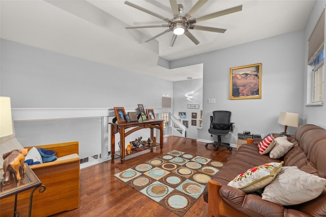 living room with ceiling fan and dark hardwood / wood-style flooring