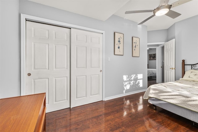 bedroom featuring dark hardwood / wood-style flooring, a closet, and ceiling fan