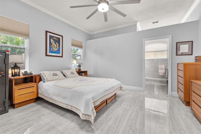 bedroom featuring ensuite bath, ceiling fan, multiple windows, and ornamental molding