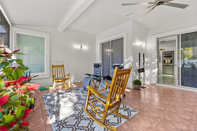 interior space featuring lofted ceiling with beams and ceiling fan