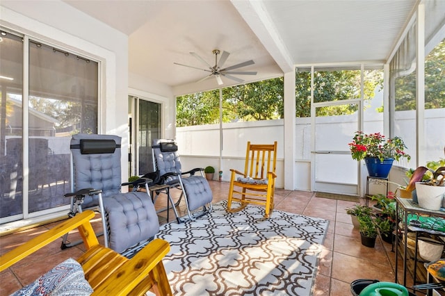 sunroom with vaulted ceiling with beams and ceiling fan