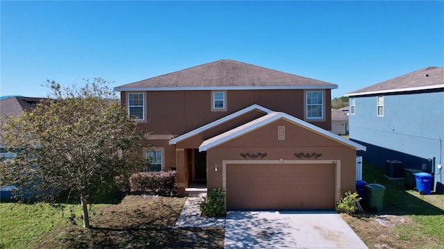 front of property featuring a garage and cooling unit