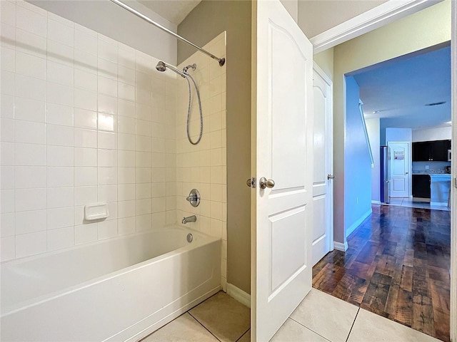 bathroom featuring tile patterned floors and tiled shower / bath combo