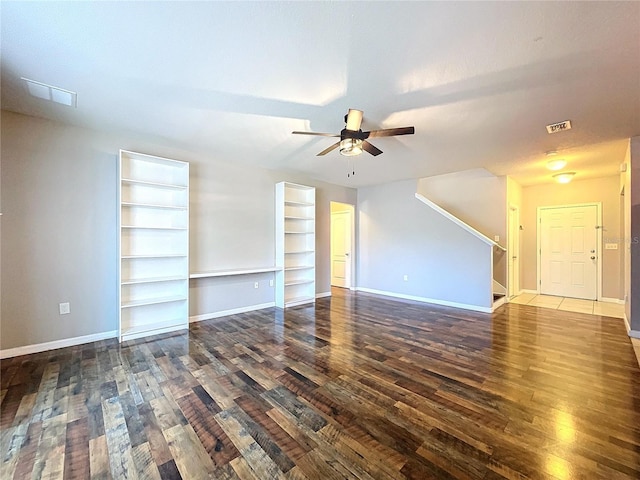 unfurnished room with ceiling fan and dark wood-type flooring