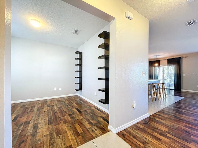 interior space with hardwood / wood-style floors and a textured ceiling