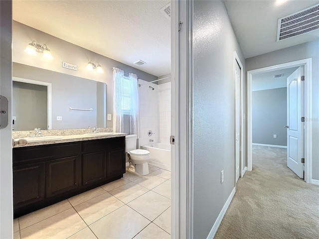 full bathroom featuring vanity, bathing tub / shower combination, tile patterned floors, toilet, and a textured ceiling