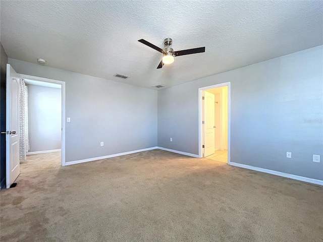 carpeted empty room with a textured ceiling and ceiling fan