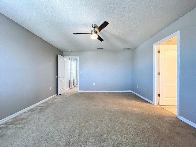 empty room with a textured ceiling, ceiling fan, and light carpet