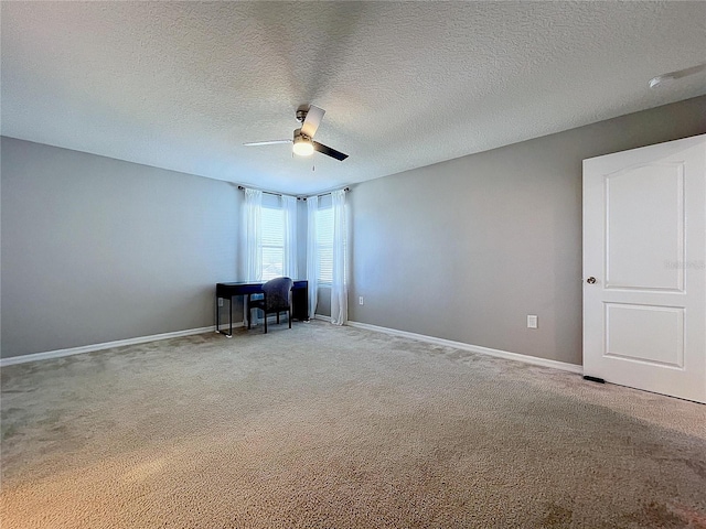 interior space featuring ceiling fan, carpet, and a textured ceiling