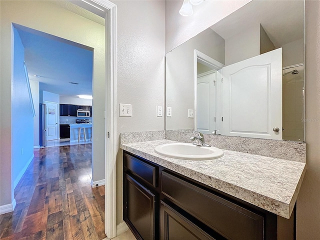 bathroom featuring hardwood / wood-style floors and vanity