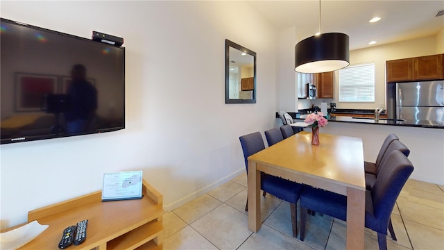 tiled dining area featuring sink