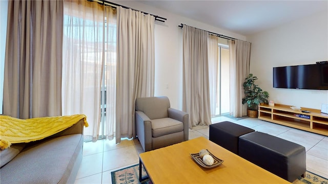 living room with light tile patterned floors and plenty of natural light