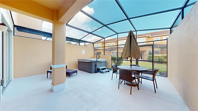 view of patio / terrace featuring a lanai and a hot tub