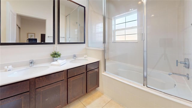 bathroom with vanity, tile patterned floors, and bath / shower combo with glass door