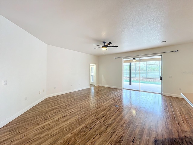 empty room with hardwood / wood-style floors, ceiling fan, and a textured ceiling