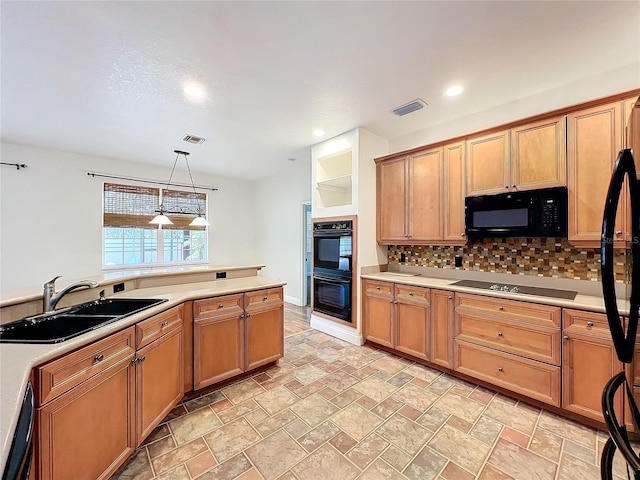 kitchen featuring black appliances, backsplash, sink, and hanging light fixtures