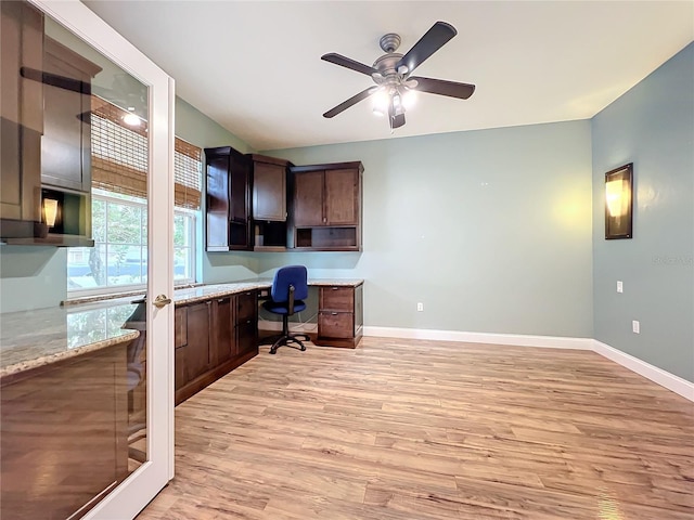 office with built in desk, light hardwood / wood-style floors, and ceiling fan