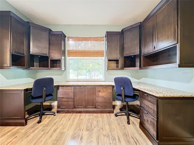 office featuring light hardwood / wood-style flooring and built in desk