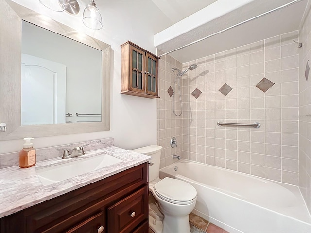 full bathroom featuring tile patterned floors, vanity, tiled shower / bath combo, and toilet