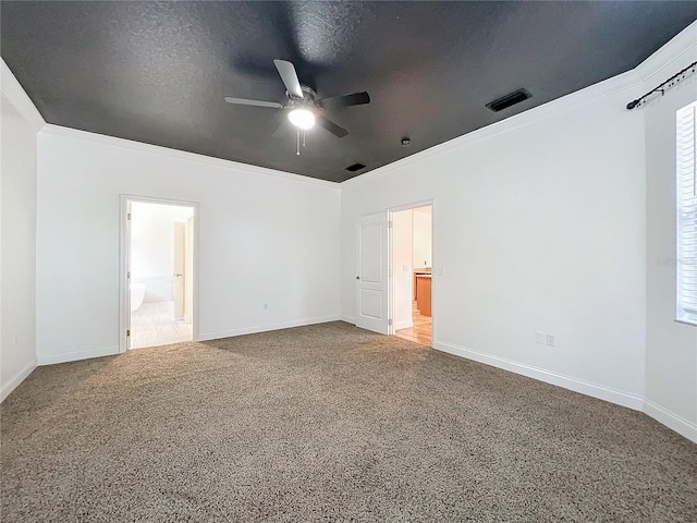 unfurnished bedroom featuring ensuite bathroom, ornamental molding, a textured ceiling, ceiling fan, and carpet floors