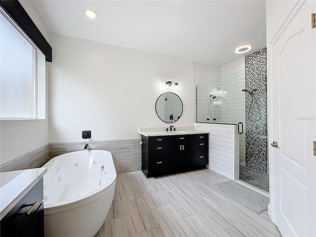 bathroom featuring separate shower and tub and vanity