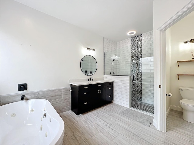 full bathroom with vanity, shower with separate bathtub, and toilet