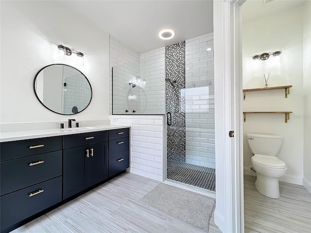 bathroom featuring vanity, toilet, and walk in shower