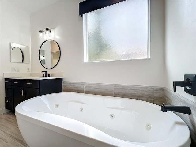 bathroom featuring wood-type flooring, vanity, and a bathtub