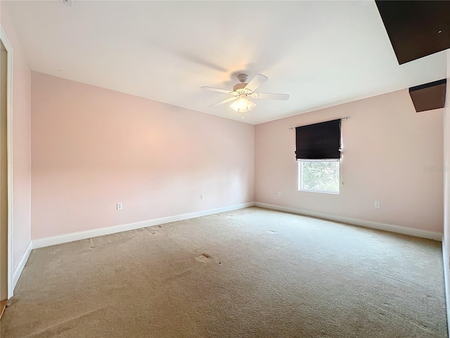 spare room featuring ceiling fan and carpet