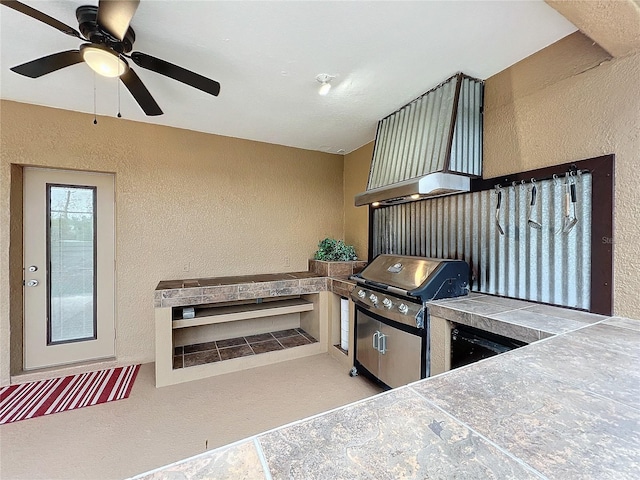 view of patio / terrace with area for grilling, a grill, and ceiling fan