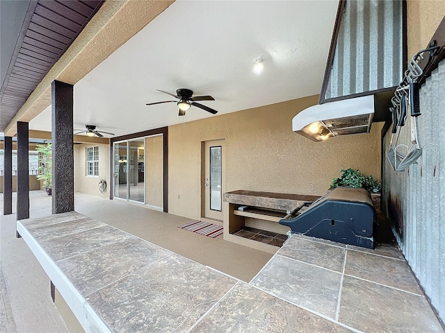 view of patio with ceiling fan and a grill