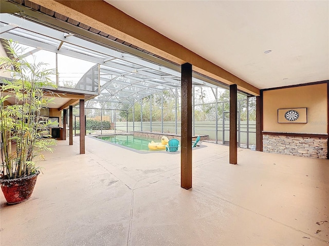 view of swimming pool with glass enclosure and a patio area