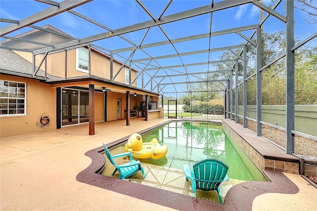 view of pool with ceiling fan, a lanai, and a patio