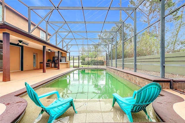 view of pool with a lanai, ceiling fan, and a patio