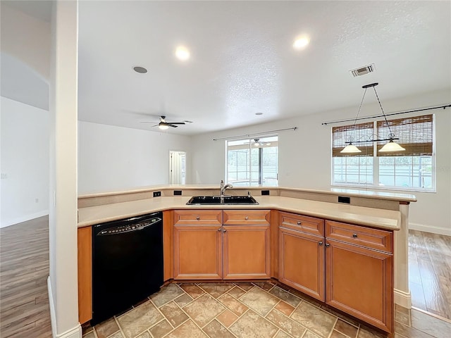 kitchen with sink, ceiling fan, a textured ceiling, black dishwasher, and decorative light fixtures