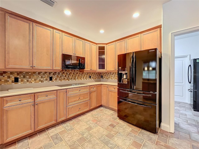 kitchen with backsplash and black appliances