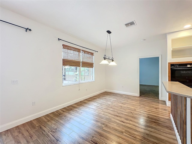 unfurnished dining area with hardwood / wood-style flooring