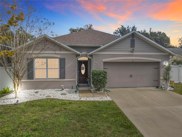 ranch-style house with a lawn and a garage