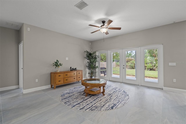 sitting room featuring ceiling fan and french doors