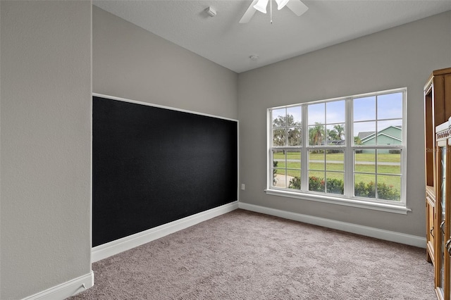 empty room with ceiling fan and carpet floors