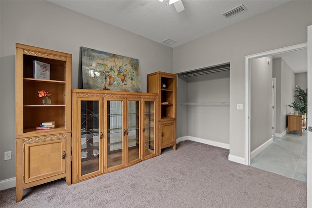 bedroom featuring carpet flooring, ceiling fan, and a closet