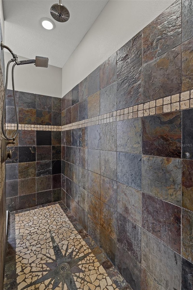 bathroom with tiled shower