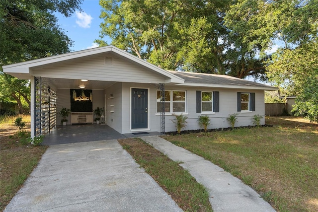 view of front of house featuring a front lawn and a carport