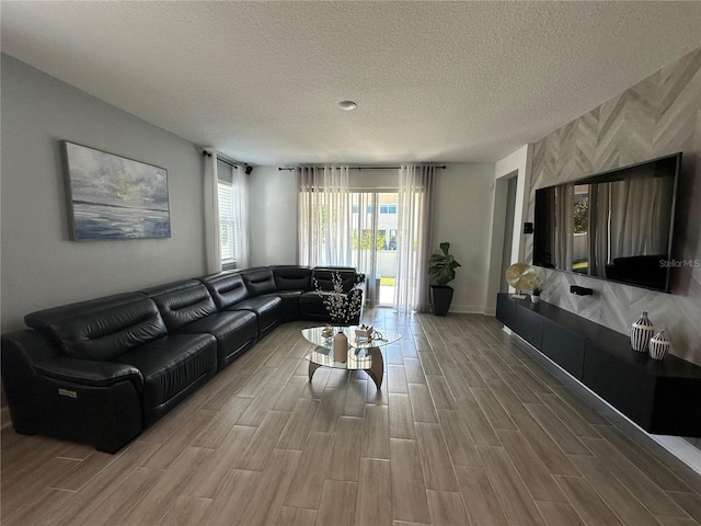 living area featuring a textured ceiling and wood finish floors