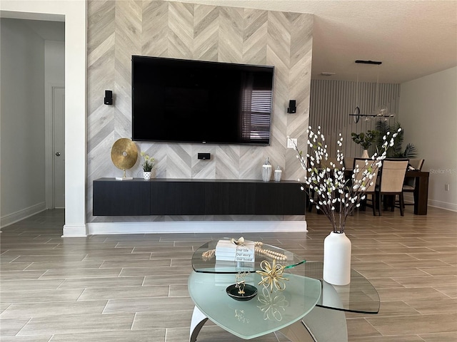 living area featuring baseboards and wood finish floors