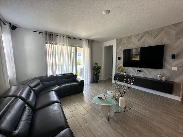 living room with a textured ceiling and wood finish floors