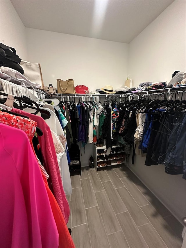 walk in closet featuring wood tiled floor