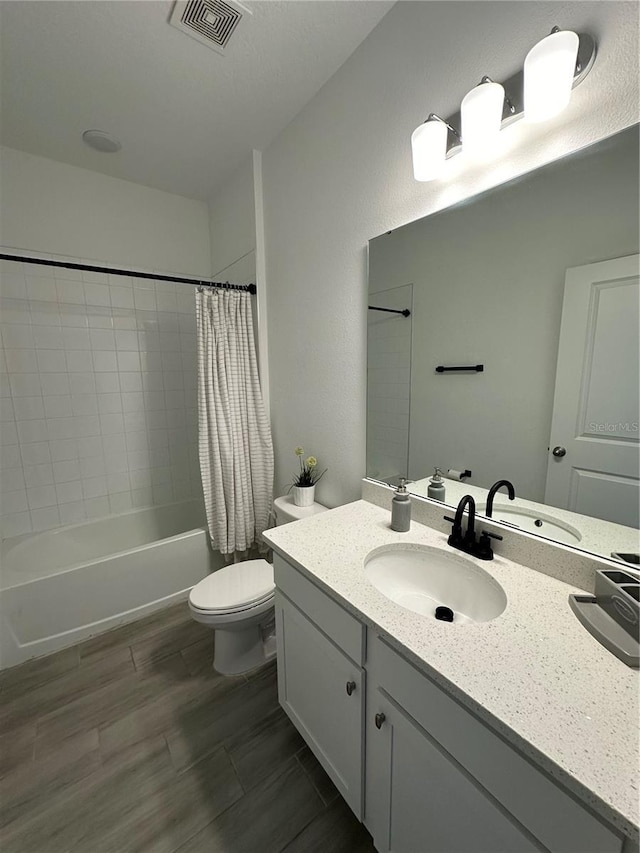 bathroom featuring visible vents, toilet, wood finished floors, shower / bathtub combination with curtain, and vanity