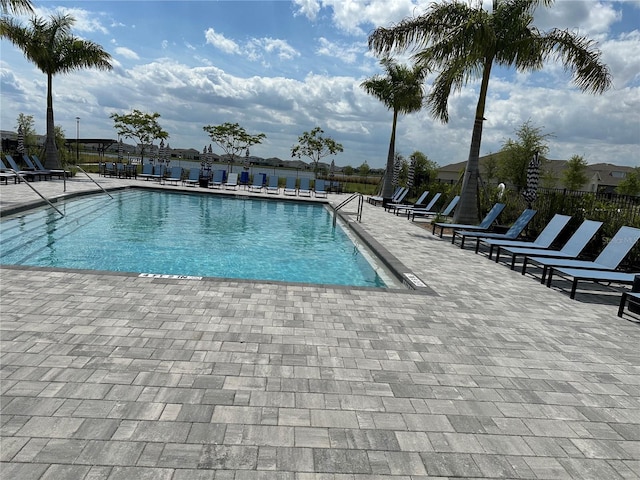 pool featuring a patio and fence