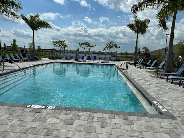 community pool featuring a patio area and fence